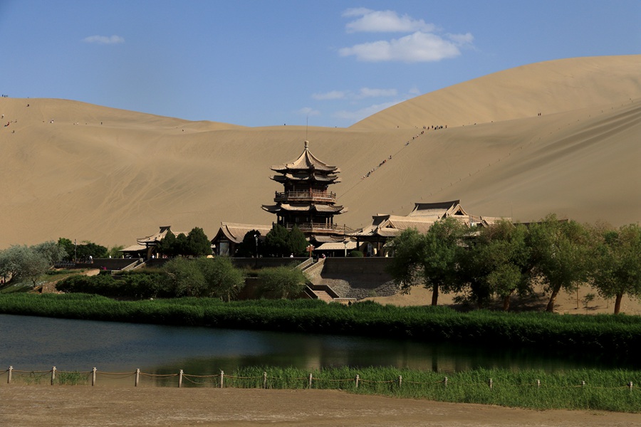 2023年5月11日，游客在甘肅省敦煌市鳴沙山月牙泉景區游覽。張曉亮攝