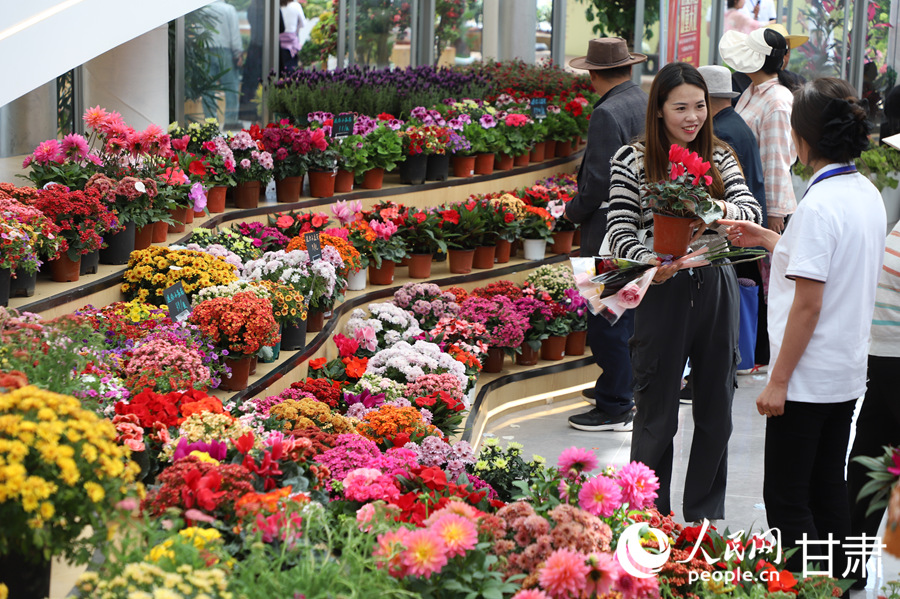 游客在臨夏市牡丹產業園花卉藝術中心內賞花游玩。人民網記者 焦隆攝